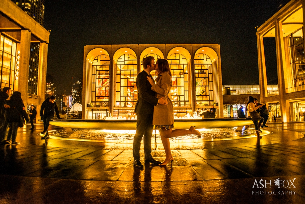 future wife kissing man in front of fountain