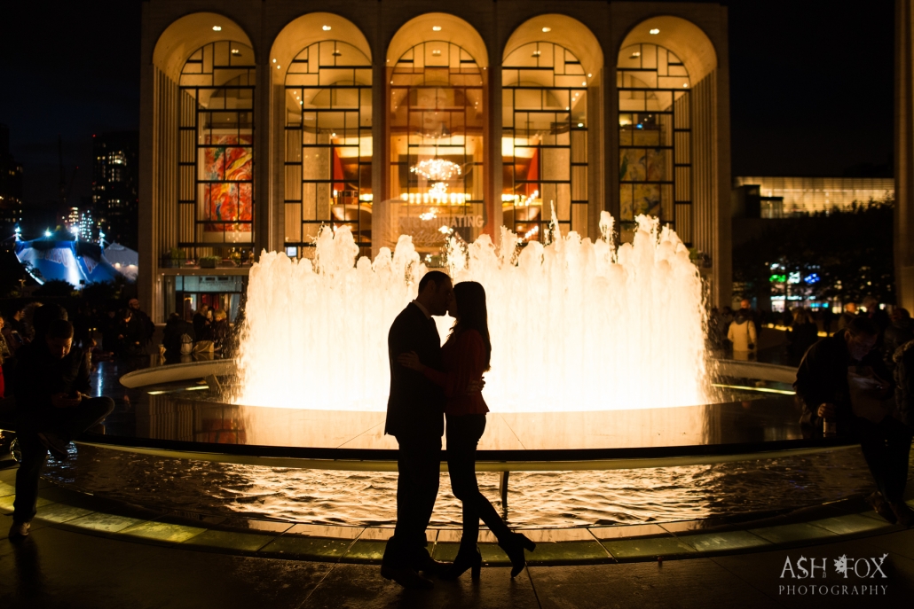 groom and bride kissing by fountain